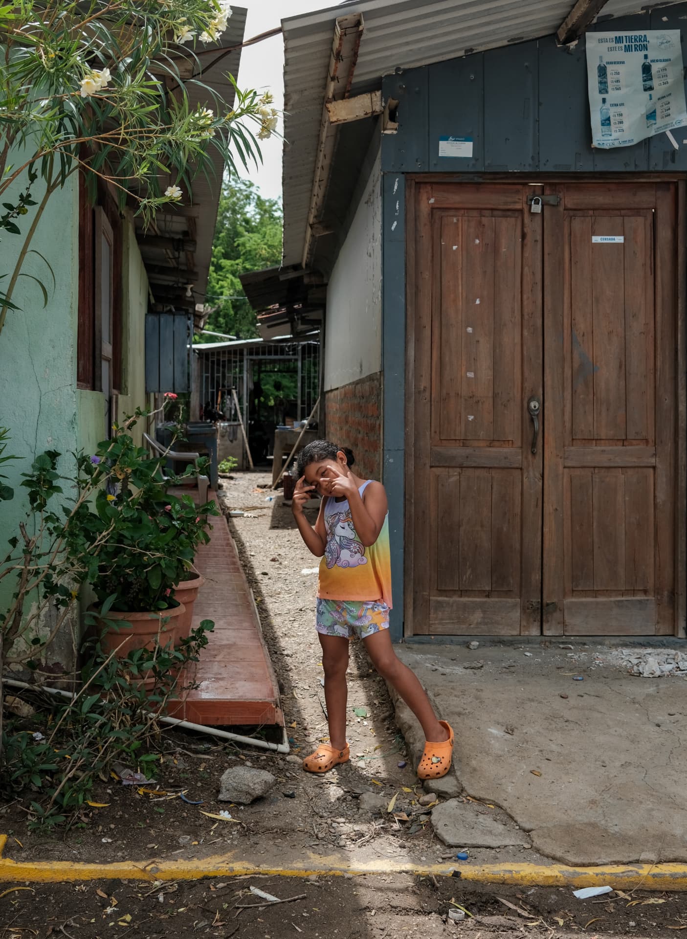 A young girl posing on a dirt lane between houses in Gigante, Nicaragua